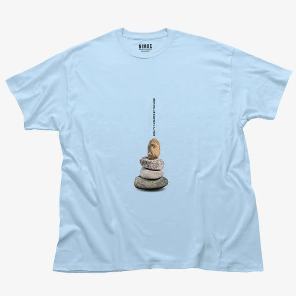 Reality is created by the mind unisex classic t-shirt in light blue color displaying stones stacked in balance.